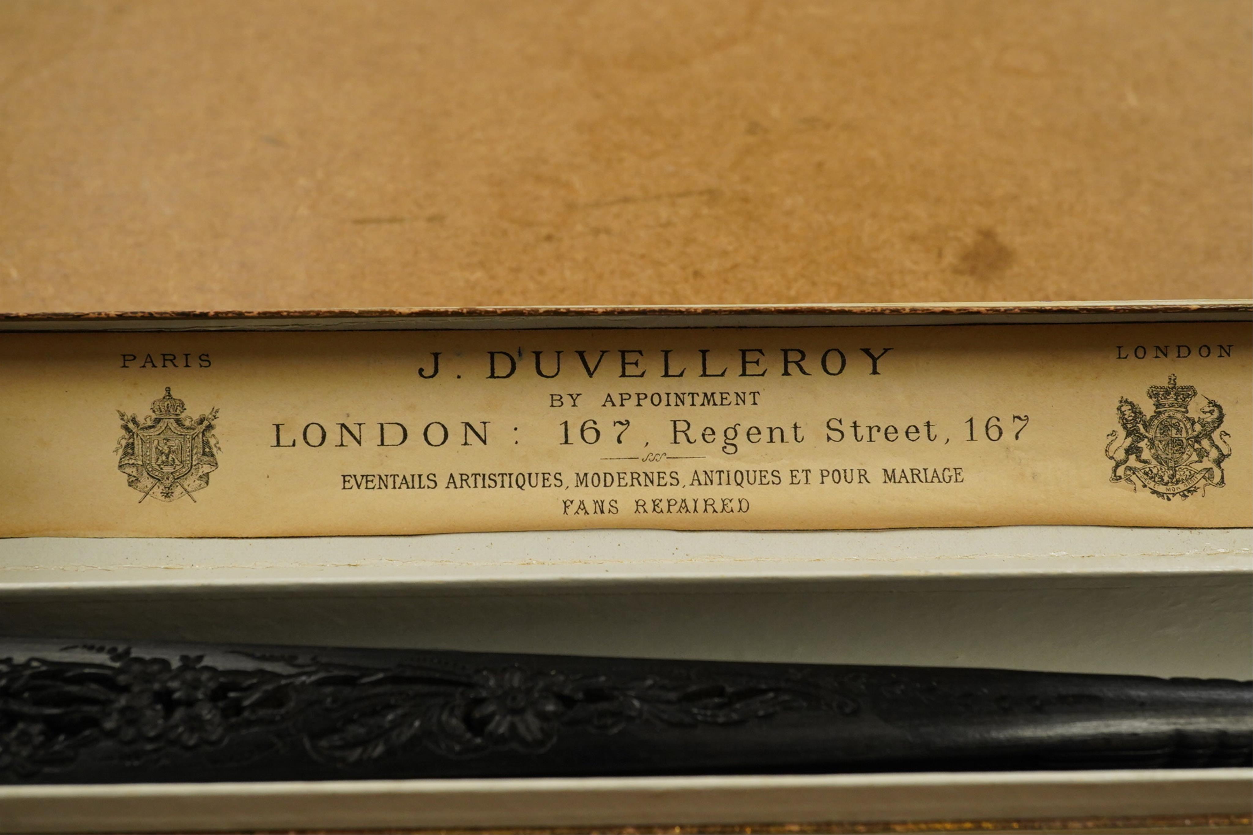 An Edwardian evening fan with black silk gauze, decorated sequin and lace trimmed leaf with carved ebonised guards and stems, in a fan box by J. D’uvelleroy. Condition - fair to good